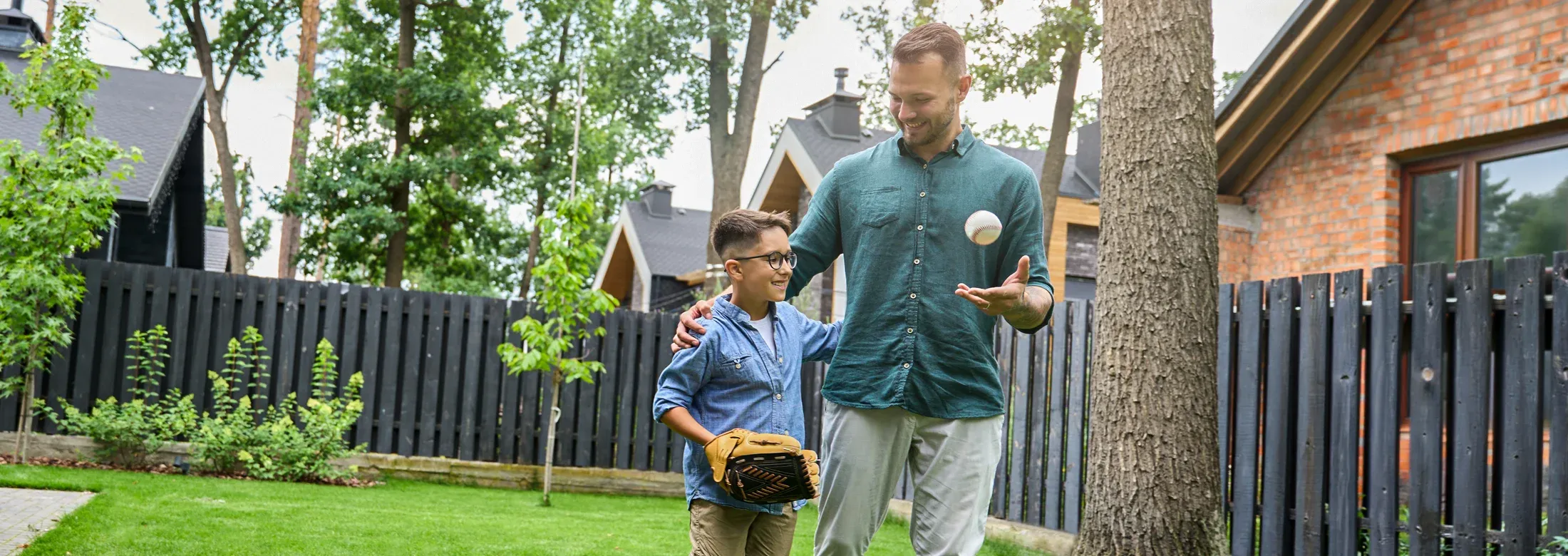 father and son playing baseball in a mosquito free back yard